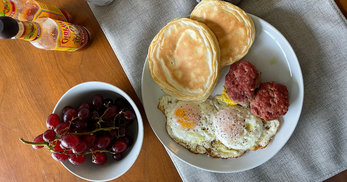 Balanced meal of pancakes and protein-rich sides to support satiety and reduce binge cycles