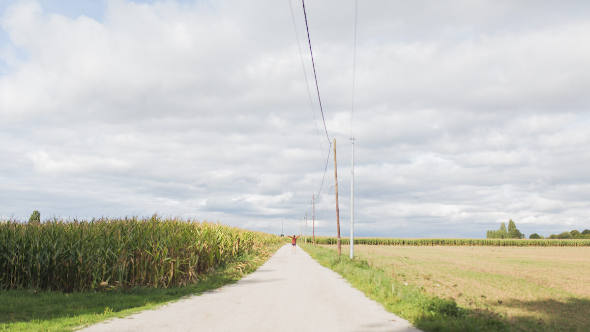 Woman in Field with Arms Outstretched